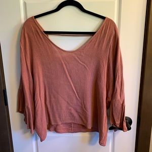 Oversized open back pink blouse.